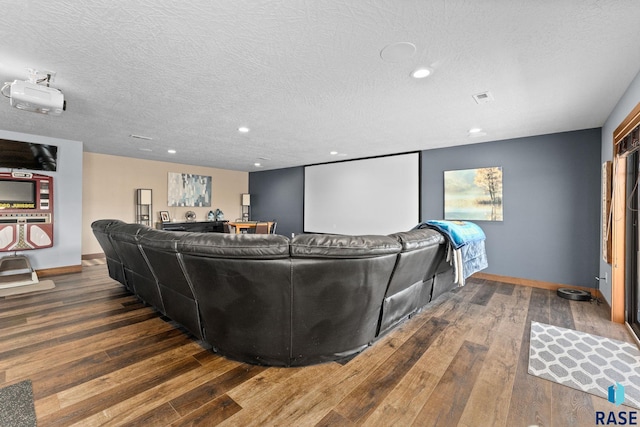 cinema featuring visible vents, recessed lighting, hardwood / wood-style flooring, and a textured ceiling