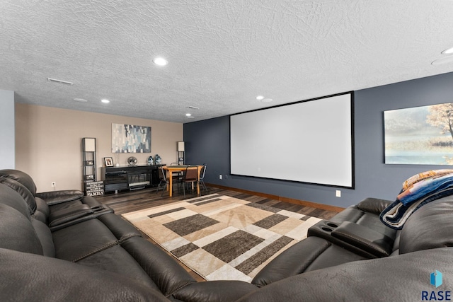cinema featuring recessed lighting, wood finished floors, and a textured ceiling