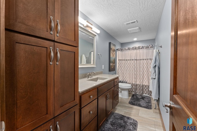 bathroom featuring vanity, a textured ceiling, toilet, shower / bathtub combination with curtain, and visible vents