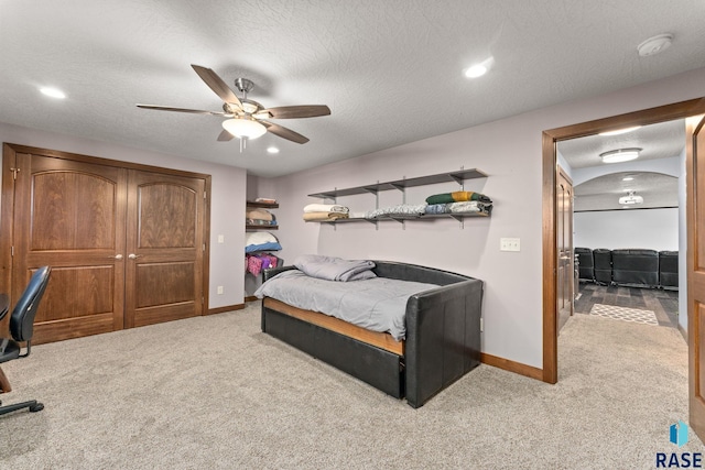 bedroom featuring carpet flooring, a textured ceiling, and baseboards