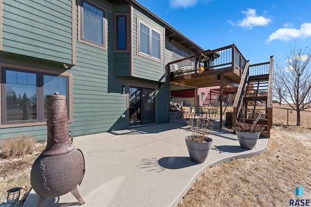 exterior space with a patio, stairway, a wooden deck, and fence