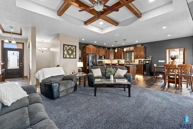 living area with a textured ceiling, beamed ceiling, and coffered ceiling