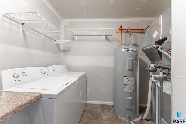laundry area with washer and clothes dryer, water heater, laundry area, and baseboards