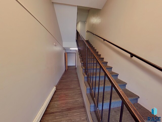 320 N Western Ave, Sioux Falls, SD 57104 - staircase with a baseboard heating unit, baseboards, and wood finished floors