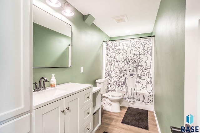 full bathroom with toilet, wood finished floors, vanity, and shower / bathtub combination with curtain