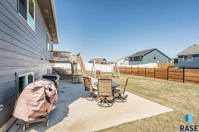 view of patio / terrace featuring a fenced backyard, stairway, and a residential view