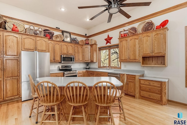 7 N Sun Valley Pl, Sioux Falls, SD 57110 - kitchen with a sink, a center island, light wood finished floors, and stainless steel appliances