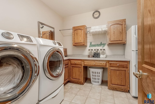 7 N Sun Valley Pl, Sioux Falls, SD 57110 - clothes washing area featuring independent washer and dryer, light tile patterned flooring, and cabinet space
