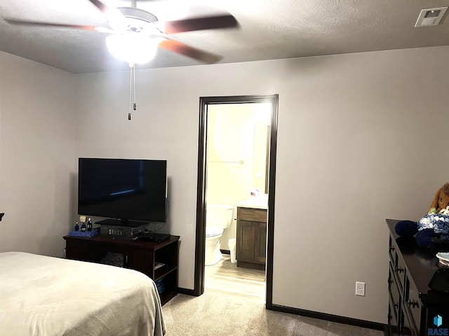 bedroom featuring baseboards, light carpet, a ceiling fan, connected bathroom, and visible vents