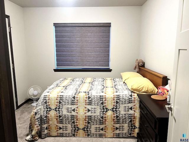 bedroom with baseboards and carpet