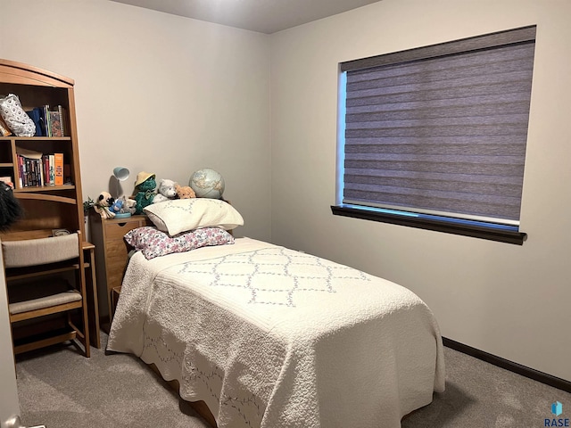 bedroom featuring baseboards and carpet flooring