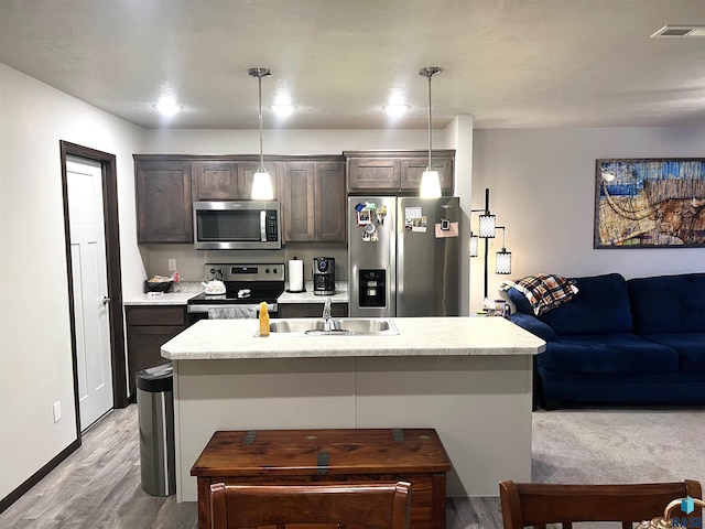 kitchen with light countertops, dark brown cabinets, visible vents, and stainless steel appliances