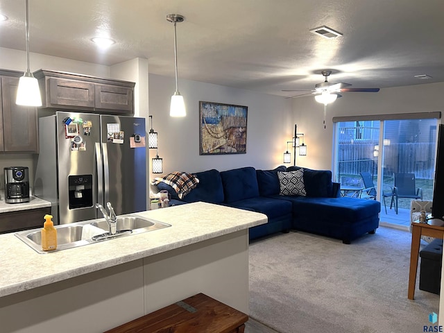 living room with visible vents, light colored carpet, a textured ceiling, and ceiling fan