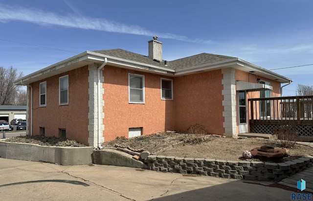 1413 E Rice St, Sioux Falls, SD 57103 - view of side of home with a wooden deck, a chimney, and a shingled roof