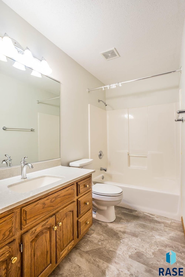 full bath featuring vanity, a textured ceiling, toilet, visible vents, and shower / bathing tub combination