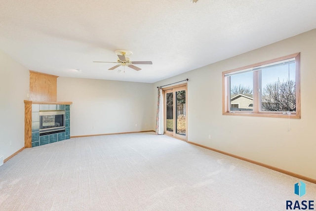 unfurnished living room featuring baseboards, a ceiling fan, and light colored carpet