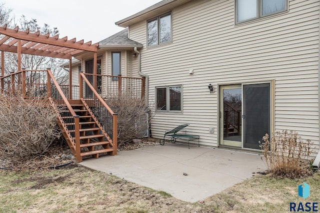 back of house featuring a wooden deck, stairs, a patio, and a pergola