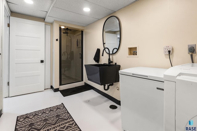 full bath featuring recessed lighting, vanity, concrete floors, a stall shower, and washer / clothes dryer