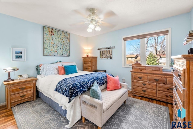 bedroom featuring wood finished floors, ceiling fan, and baseboards