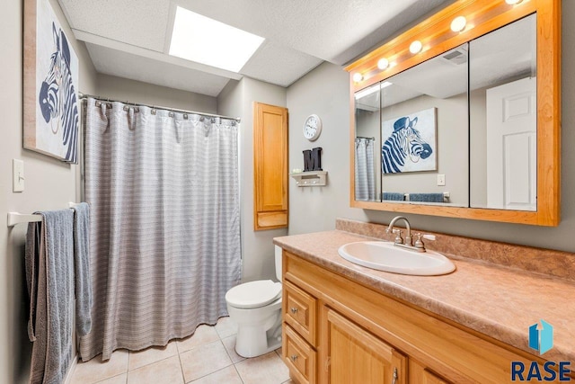 full bathroom with vanity, curtained shower, tile patterned floors, toilet, and a skylight