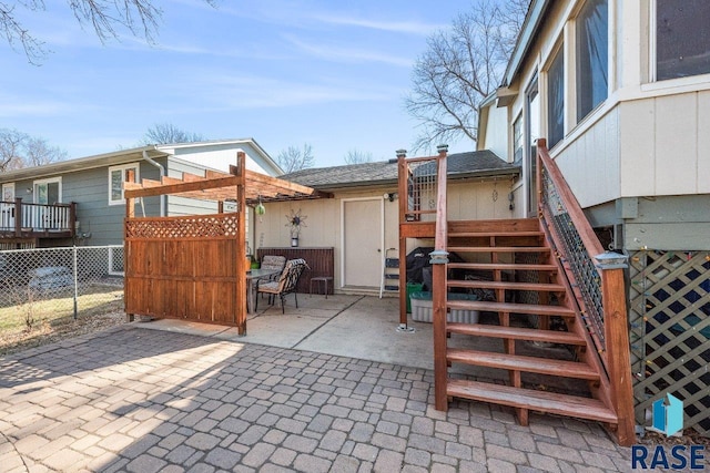 view of patio / terrace with fence and stairs