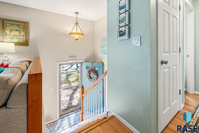 interior space featuring baseboards and wood finished floors