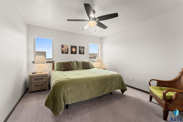 bedroom featuring light carpet, baseboards, and multiple windows
