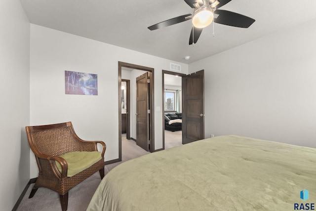 bedroom with visible vents, light colored carpet, baseboards, and a ceiling fan