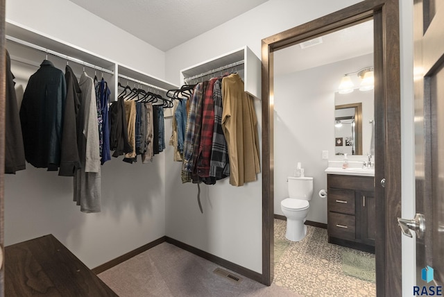 spacious closet featuring a sink and visible vents
