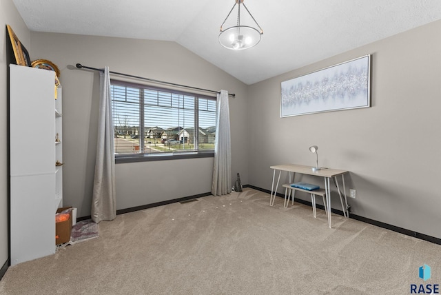 interior space featuring baseboards, an inviting chandelier, visible vents, lofted ceiling, and carpet