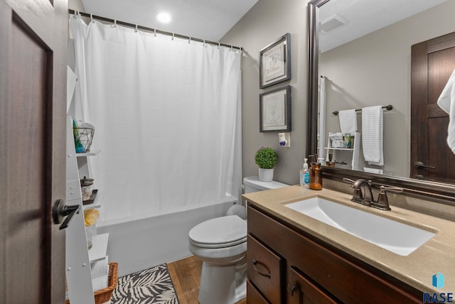 bathroom featuring visible vents, shower / bath combination with curtain, toilet, vanity, and wood finished floors