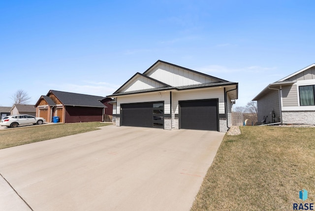 view of front of house featuring board and batten siding, a front lawn, a garage, and concrete driveway