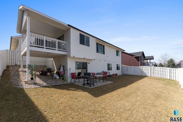 rear view of property with a patio, a fenced backyard, and a lawn