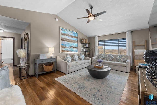 living area with a ceiling fan, vaulted ceiling, wood finished floors, and a textured ceiling