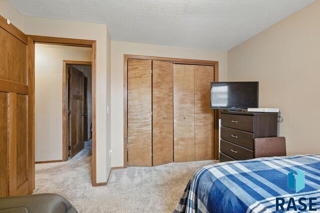 7705 W Vista Park St, Sioux Falls, SD 57106 - carpeted bedroom featuring a textured ceiling, a closet, and baseboards