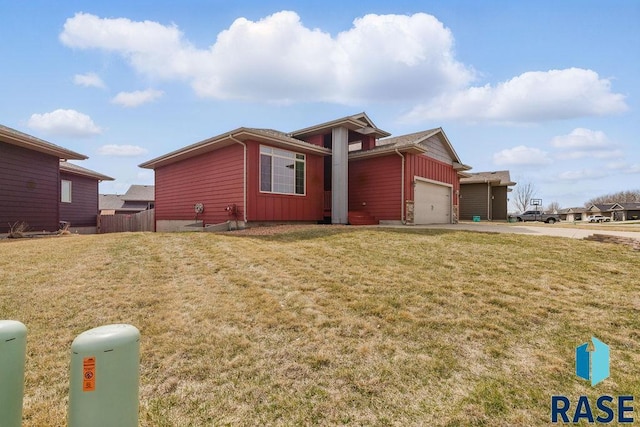 7705 W Vista Park St, Sioux Falls, SD 57106 - view of side of home with a yard, driveway, board and batten siding, and an attached garage