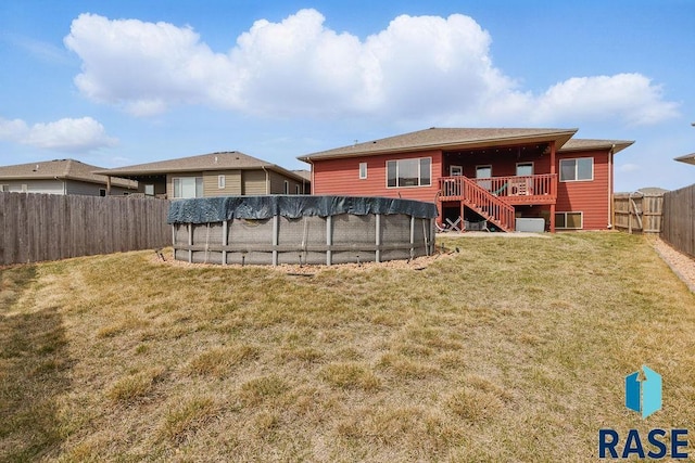 7705 W Vista Park St, Sioux Falls, SD 57106 - rear view of property with a fenced in pool, stairs, a fenced backyard, a wooden deck, and a yard