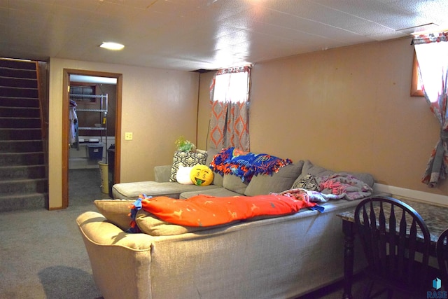 living area featuring baseboards, carpet, and stairs