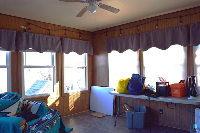 office with wood walls and ceiling fan