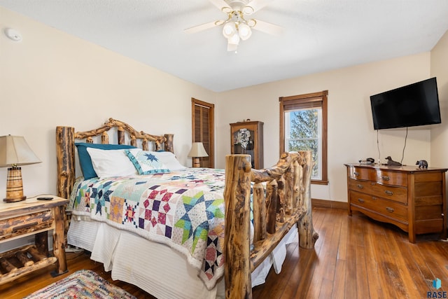 bedroom with baseboards, a ceiling fan, and hardwood / wood-style flooring