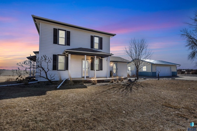 view of front of house featuring driveway, a porch, and a garage