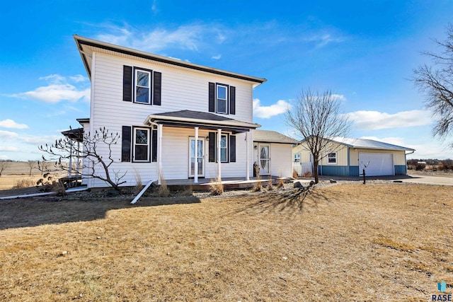 view of front facade with a porch, a garage, driveway, and a front lawn