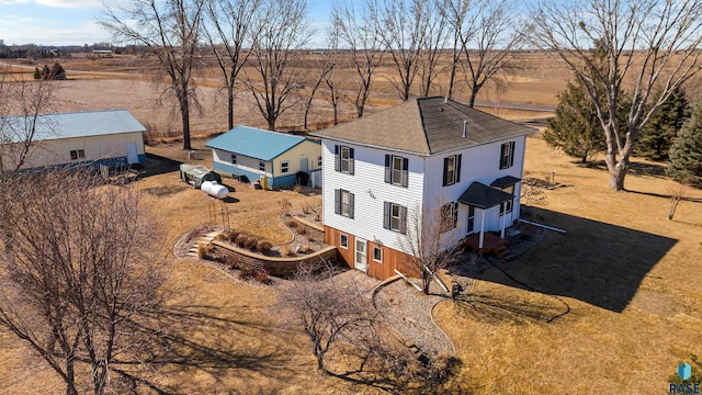 birds eye view of property with a rural view