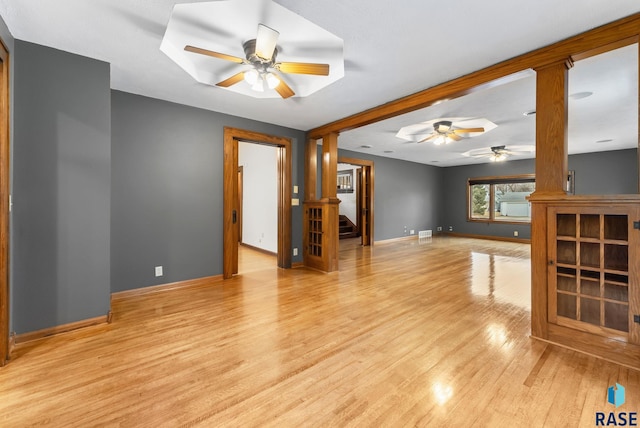209 S 3rd St, Beresford, SD 57004 - unfurnished living room with baseboards, a ceiling fan, wood finished floors, and stairs