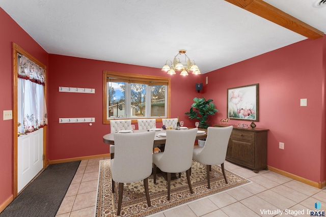 209 S 3rd St, Beresford, SD 57004 - dining space with a chandelier, light tile patterned flooring, and baseboards