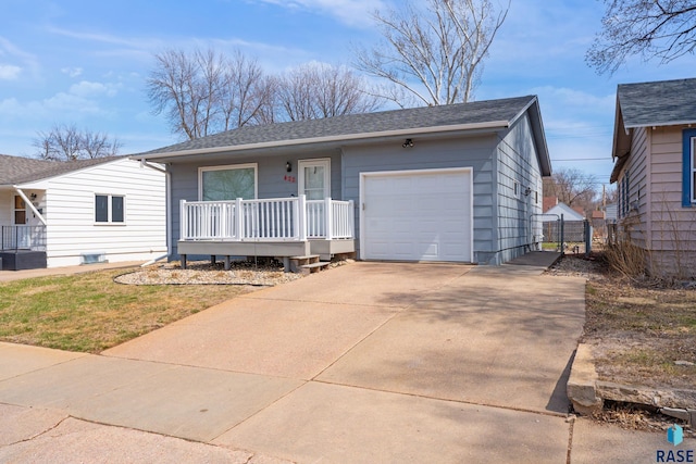 ranch-style house with a porch, a shingled roof, driveway, and an attached garage