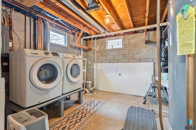 washroom with laundry area, a healthy amount of sunlight, and washer and clothes dryer