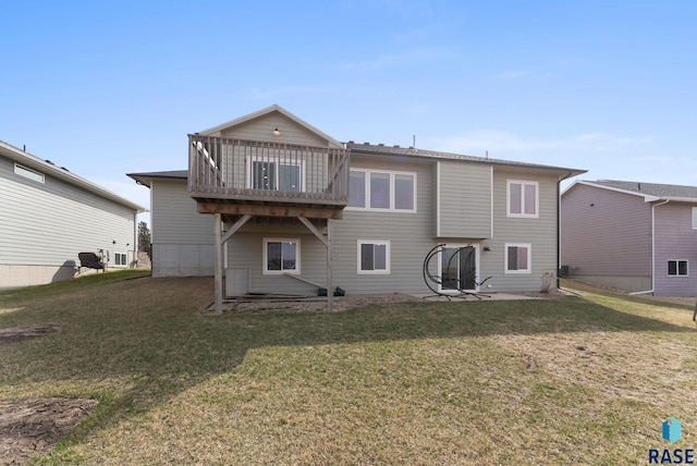 back of property with a patio, a yard, and a wooden deck