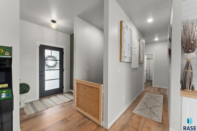 entrance foyer with baseboards and wood finished floors