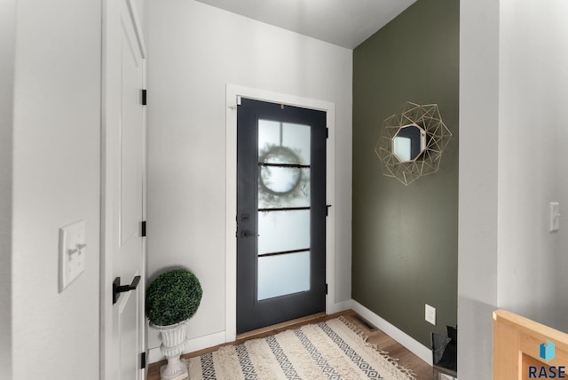 entrance foyer featuring light wood-style flooring and baseboards